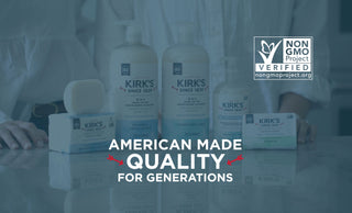 Four Kirk’s soap products are displayed on a table with two people standing behind them. The text reads: American Made Quality for Generations and shows the Non GMO Project Verified logo.